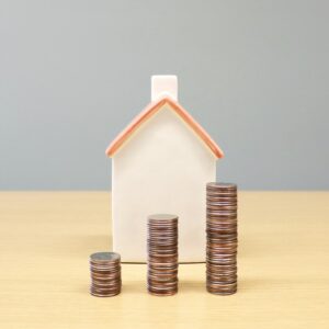 Home behind staakc of coins